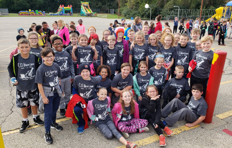 Students in walkathon tshirts on playground